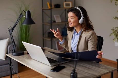 A lawyer at home wearing headphones during a remote deposition